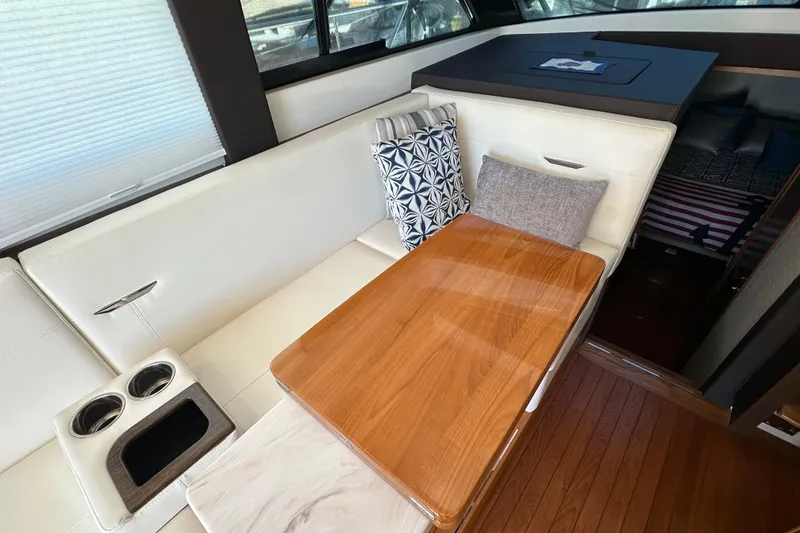Slide: The Image of Interior of 2018 Tiara Yachts C39 Coupe with elegant seating and wooden table. - 22