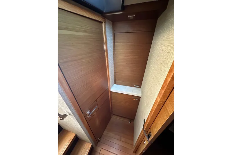 Slide: The Image of 2018 Tiara Yachts C39 Coupe interior with wooden cabinetry and flooring. - 24