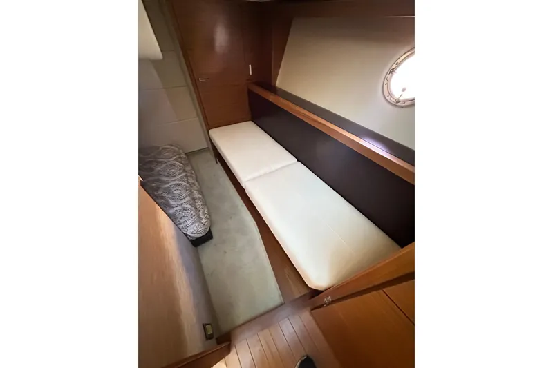 Slide: The Image of 2018 Tiara Yachts C39 Coupe cabin interior with twin beds and wooden finish. - 25