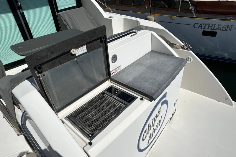 Slide: The Image of Outdoor kitchen area on 2018 Tiara Yachts C39 Coupe, featuring grill and countertop. - 6