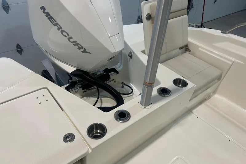 Slide: The Image of 2025 Boston Whaler 220 Dauntless boat interior with Mercury engine and seating area. - 12