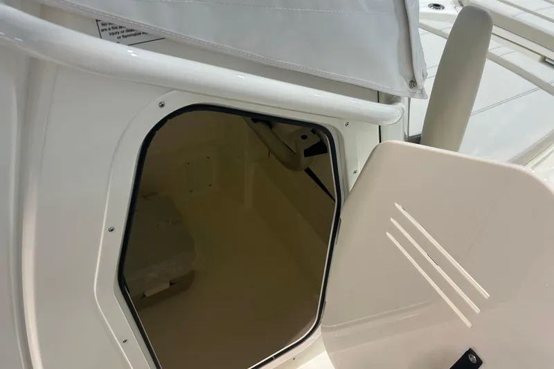 Slide: The Image of 2025 Boston Whaler 220 Dauntless interior storage compartment with open hatch. - 20