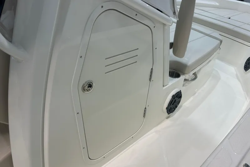 Slide: The Image of 2025 Boston Whaler 220 Dauntless boat interior with storage compartment and seating. - 22