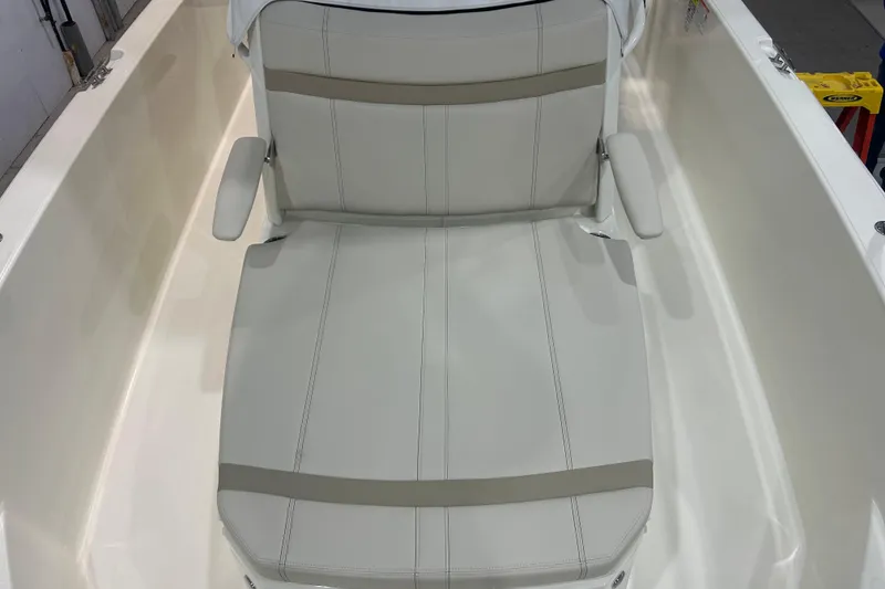 Slide: The Image of 2025 Boston Whaler 220 Dauntless boat seat with armrests, white upholstery. - 24