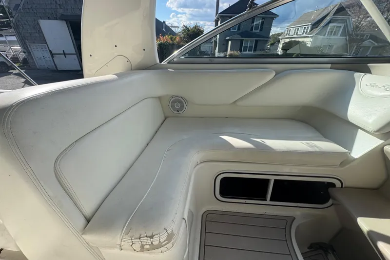 Slide: The Image of Interior of 2004 Sea Ray 260 Sundancer boat with white seating and speaker. - 4