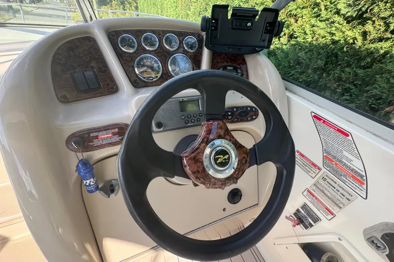 Slide: The Image of Steering console of a 2004 Sea Ray 260 Sundancer boat with gauges and controls. - 6