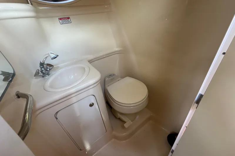 Slide: The Image of 2004 Sea Ray 260 Sundancer bathroom with sink and toilet. - 8