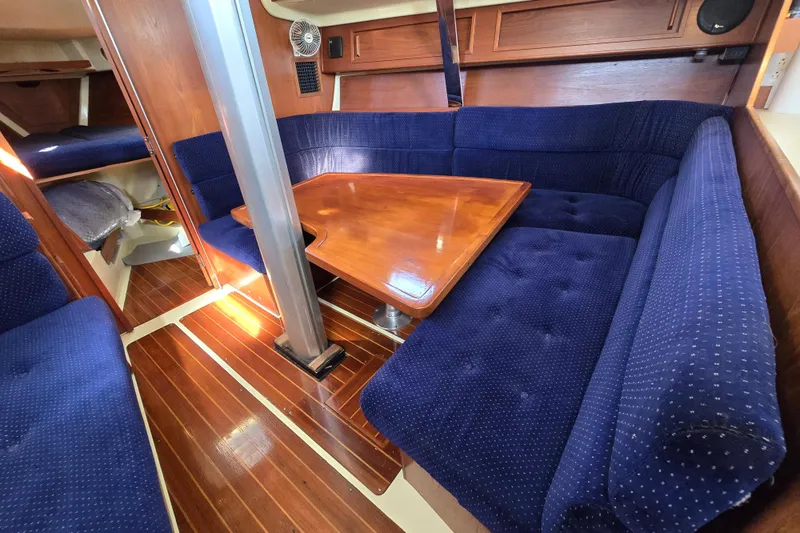 Slide: The Image of 1988 Pearson 362 Centerboard interior with blue upholstery and wooden table. - 12