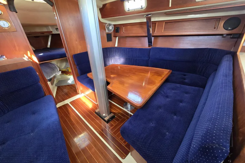 Slide: The Image of 1988 Pearson 362 Centerboard yacht interior with blue upholstery and wooden table. - 13
