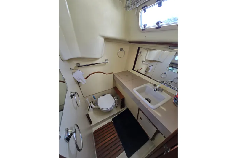 Slide: The Image of 1988 Pearson 362 Centerboard yacht bathroom with sink, toilet, and mirror. - 16