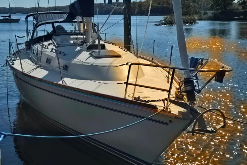Slide: The Image of 1988 Pearson 362 Centerboard sailboat docked on shimmering water. - 2