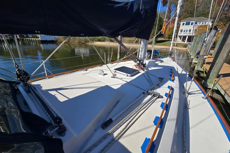 Slide: The Image of 1988 Pearson 362 Centerboard sailboat docked, showcasing deck and rigging details. - 27