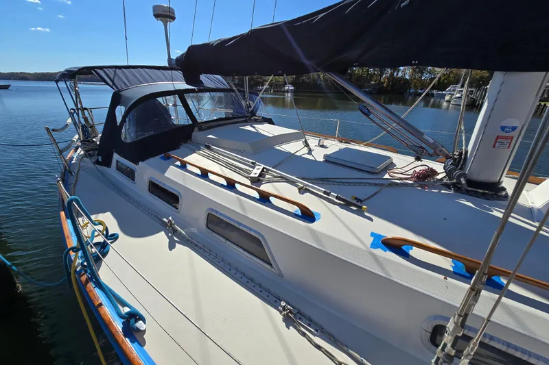 Slide: The Image of 1988 Pearson 362 Centerboard sailboat docked on a sunny day, featuring a sleek design. - 6