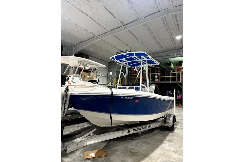 Slide: The Image of 2019 Polar 1 boat in storage, blue hull, on a trailer. - 0