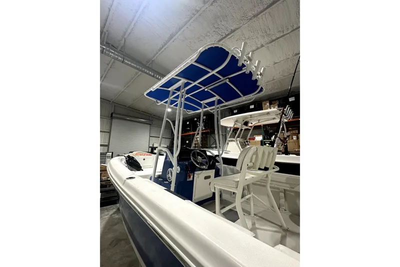 Slide: The Image of 2019 Polar 1 boat with blue canopy in indoor storage. - 1