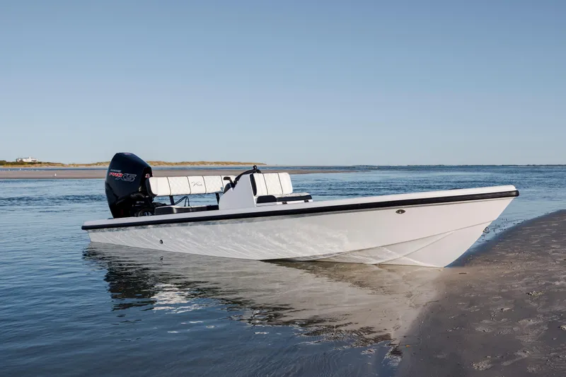 Slide: The Image of 2026 Vtech 18 boat on sandy shore with calm water background. - 11