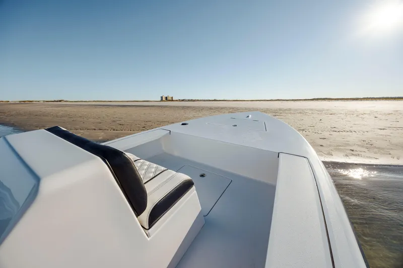Slide: The Image of Vtech 18 boat on sandy shore, 2026 model, under clear blue sky. - 12
