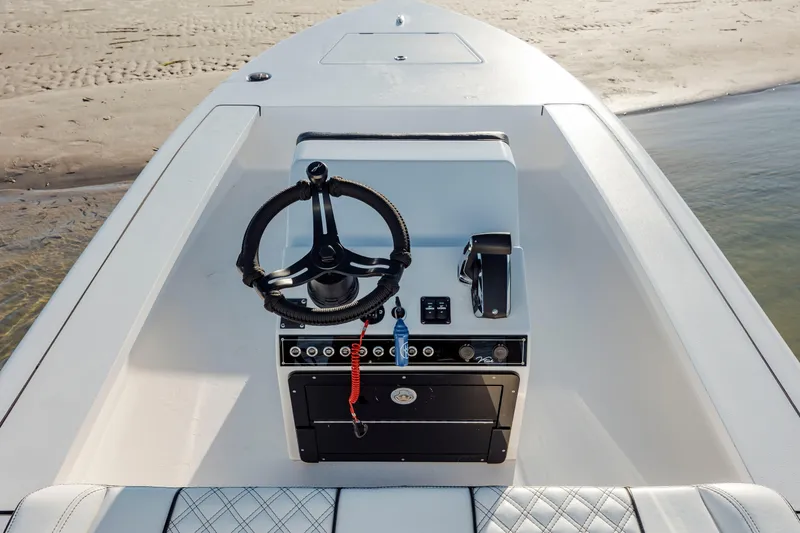 Slide: The Image of 2026 Vtech 18 boat interior with steering wheel and control panel on sandy shore. - 14