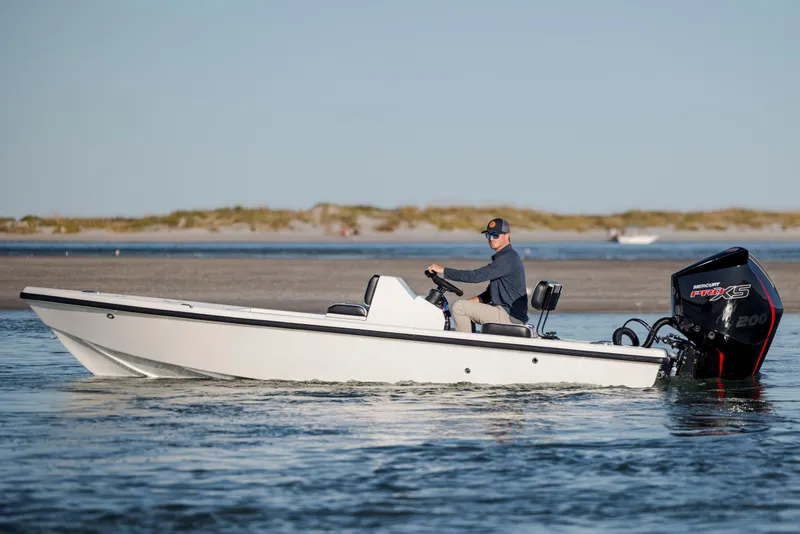 Slide: The Image of A person operates a 2026 Vtech 18 boat with a Mercury Pro XS engine. - 2