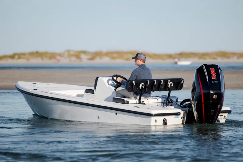 Slide: The Image of A person operates a 2026 Vtech 18 boat with a powerful outboard motor. - 3