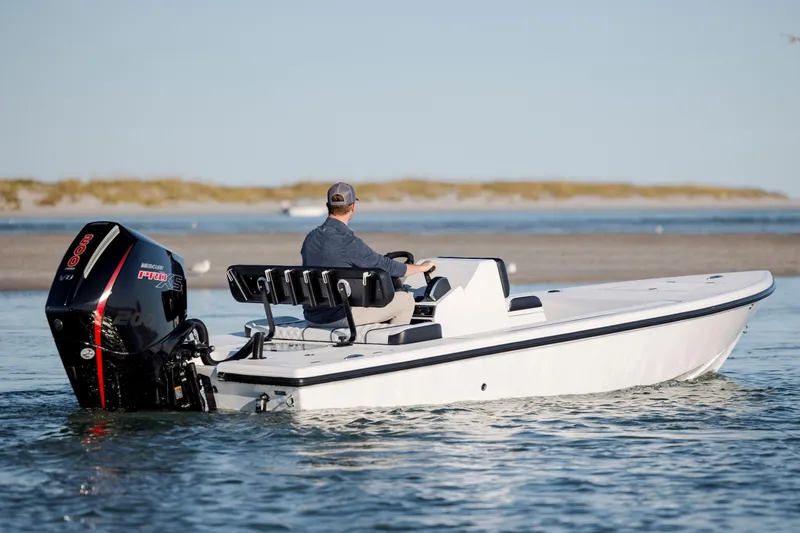 Slide: The Image of Man driving Vtech 18 boat, 2026 model, with powerful outboard motor on calm water. - 6