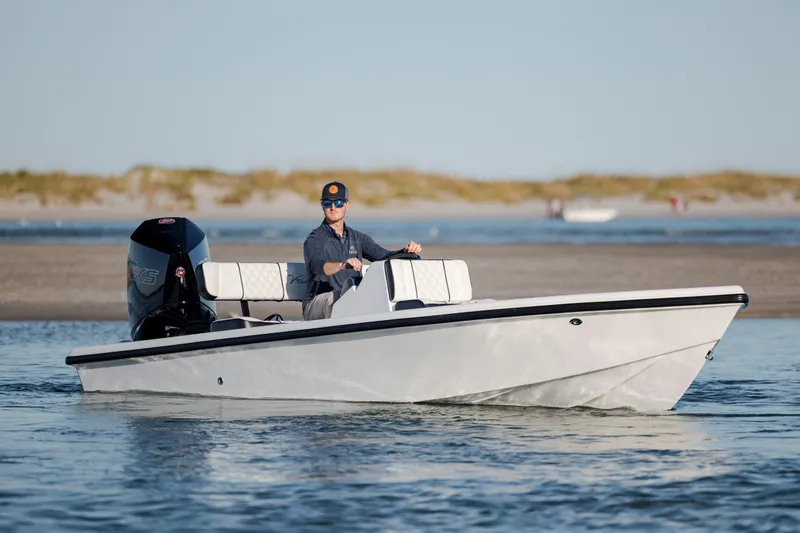 Slide: The Image of 2026 Vtech 18 boat cruising on water with driver, featuring sleek design and powerful engine. - 8