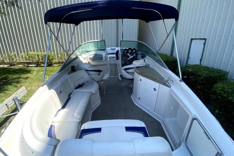 Slide: The Image of 2010 Monterey 254FS boat interior with seating, canopy, and steering console. - 24
