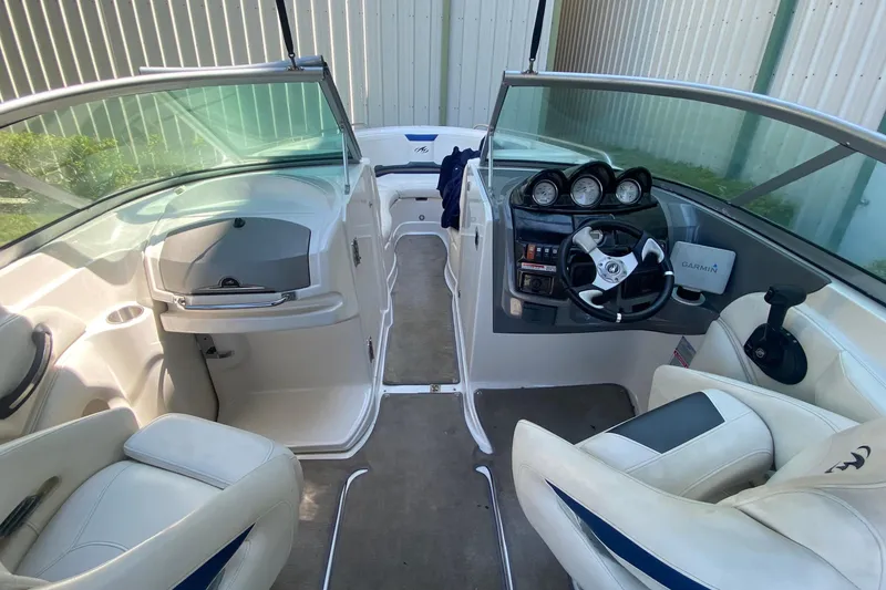 Slide: The Image of 2010 Monterey 254FS boat interior with steering wheel and seating. - 26