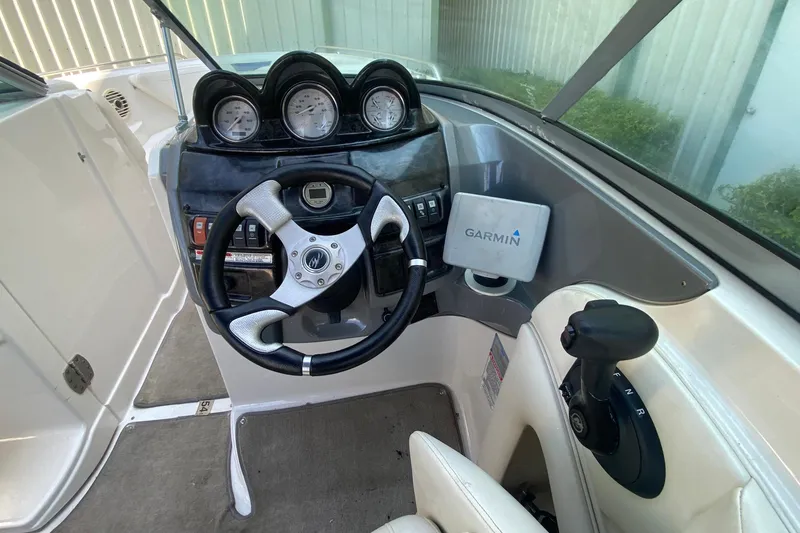 Slide: The Image of 2010 Monterey 254FS boat dashboard with steering wheel and Garmin navigation system. - 27