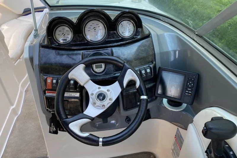 Slide: The Image of Steering console of a 2010 Monterey 254FS boat with gauges and navigation system. - 28