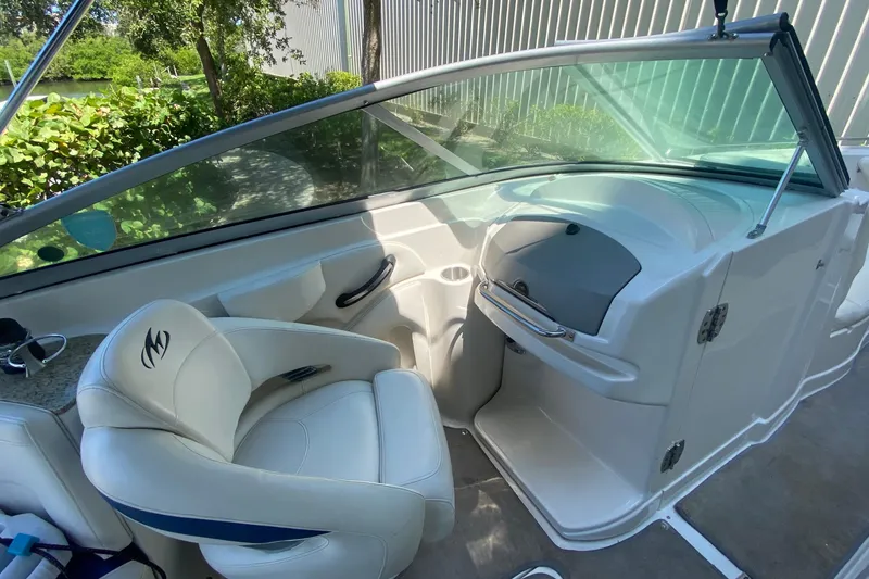 Slide: The Image of 2010 Monterey 254FS boat interior with white seating and sleek dashboard design. - 31