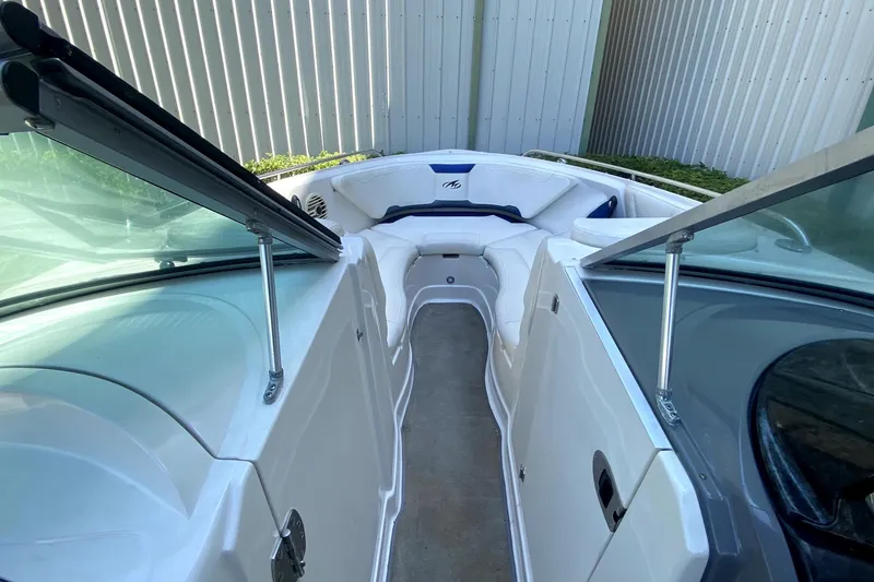 Slide: The Image of 2010 Monterey 254FS boat interior with white seating and open windshield. - 34