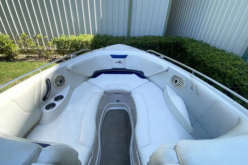 Slide: The Image of 2010 Monterey 254FS boat interior with white seating and cup holders. - 35