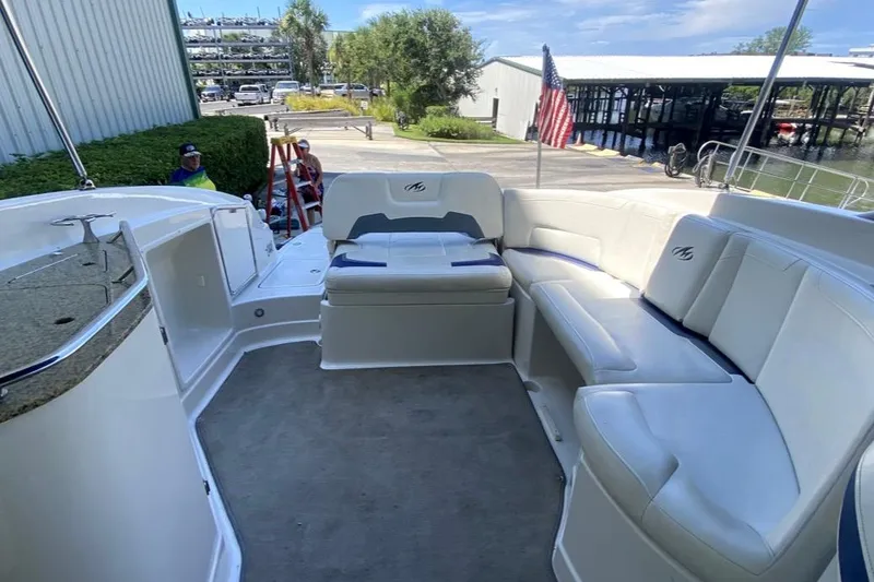 Slide: The Image of 2010 Monterey 254FS boat interior with white seating and American flag. - 37