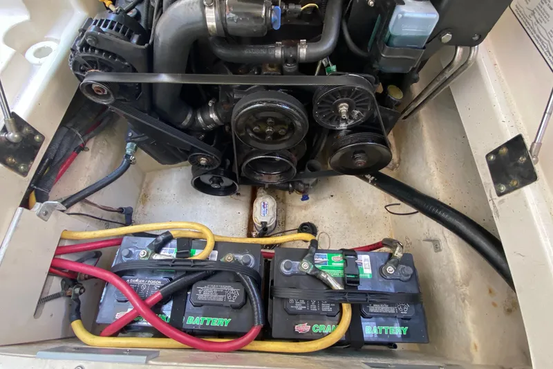 Slide: The Image of Engine compartment of a 2010 Monterey 254FS boat with visible batteries and belts. - 40