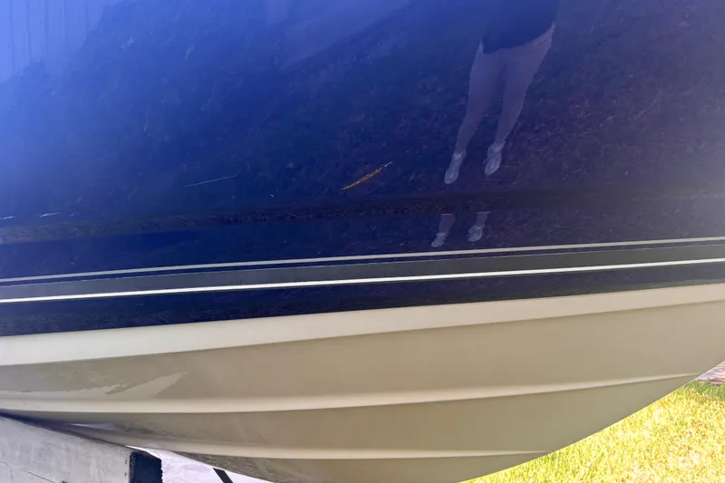 Slide: The Image of 2010 Monterey 254FS boat hull with blue and white detailing. - 5