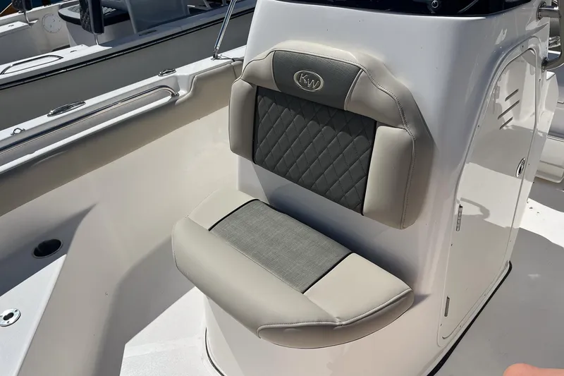 Slide: The Image of 2026 Key West 203 FS boat interior with cushioned seating and storage compartment. - 15
