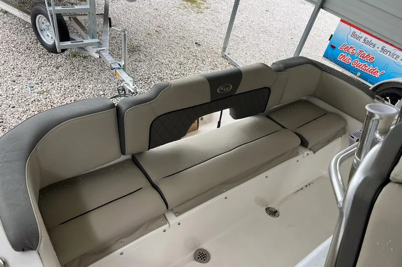 Slide: The Image of 2026 Key West 203 FS boat interior with cushioned seating and cup holders. - 17