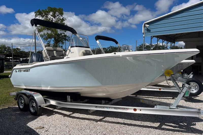 Slide: The Image of 2026 Key West 203 FS boat with sleek seating and modern design under a blue sky. - 5