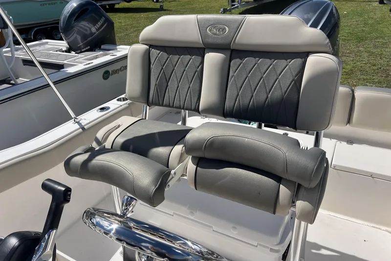 Slide: The Image of 2026 Key West 203 FS boat with Yamaha engine, featuring cushioned seating and storage compartments. - 9