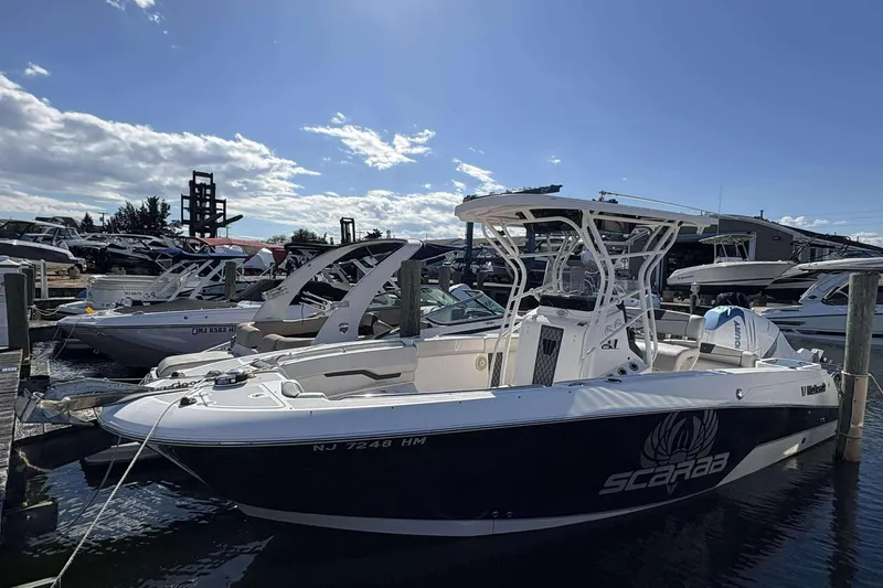 The Image of 2016 Wellcraft 242 Fisherman boat docked at marina under clear blue sky. - 1