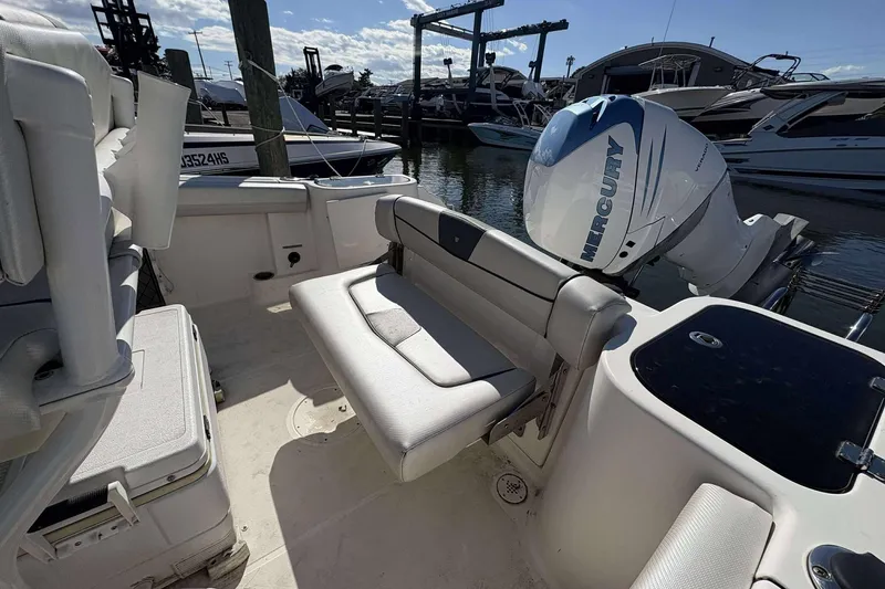 Slide: The Image of 2016 Wellcraft 242 Fisherman boat interior with Mercury engine at marina. - 10
