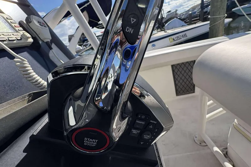 Slide: The Image of Close-up of 2016 Wellcraft 242 Fisherman boat throttle control in cockpit. - 15