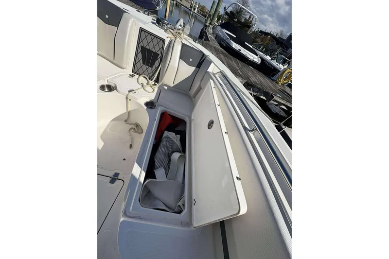 Slide: The Image of 2016 Wellcraft 242 Fisherman boat with open storage compartment at dock. - 20