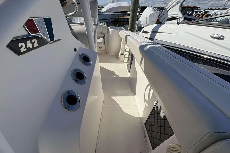 Slide: The Image of 2016 Wellcraft 242 Fisherman boat interior with rod holders and seating area. - 21