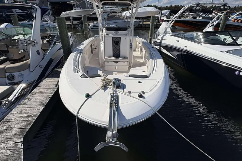 Slide: The Image of 2016 Wellcraft 242 Fisherman boat docked at marina, surrounded by other vessels. - 3