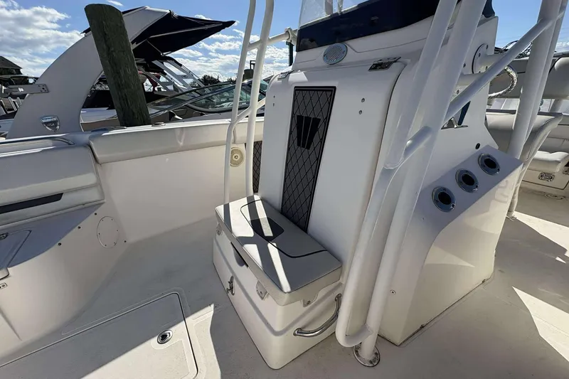 Slide: The Image of 2016 Wellcraft 242 Fisherman boat interior with seating and storage compartments. - 6