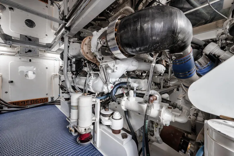 Slide: The Image of Engine room of a 1993 Merritt Sportfish boat, showcasing complex machinery and components. - 15