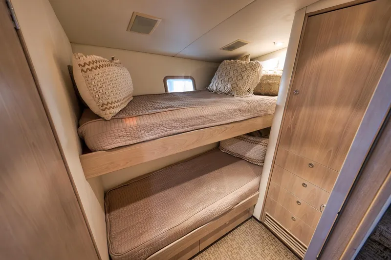 Slide: The Image of 1993 Merritt Sportfish cabin with cozy bunk beds and wooden storage. - 17