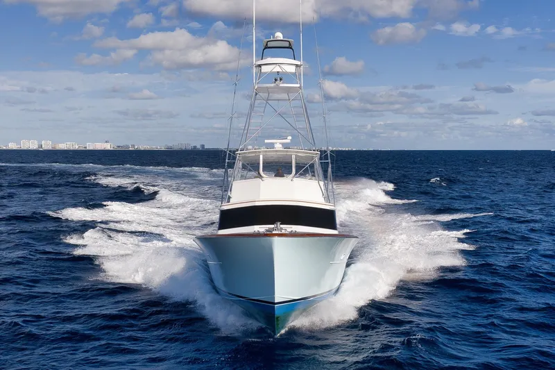 Slide: The Image of 1993 Merritt Sportfish yacht cruising on open ocean under blue sky. - 2